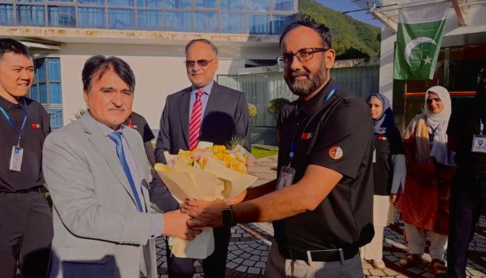 Federal Minister for Planning Ahsan Iqbal (centre) can be seen with the Suparco team in this undated image. — Suparco