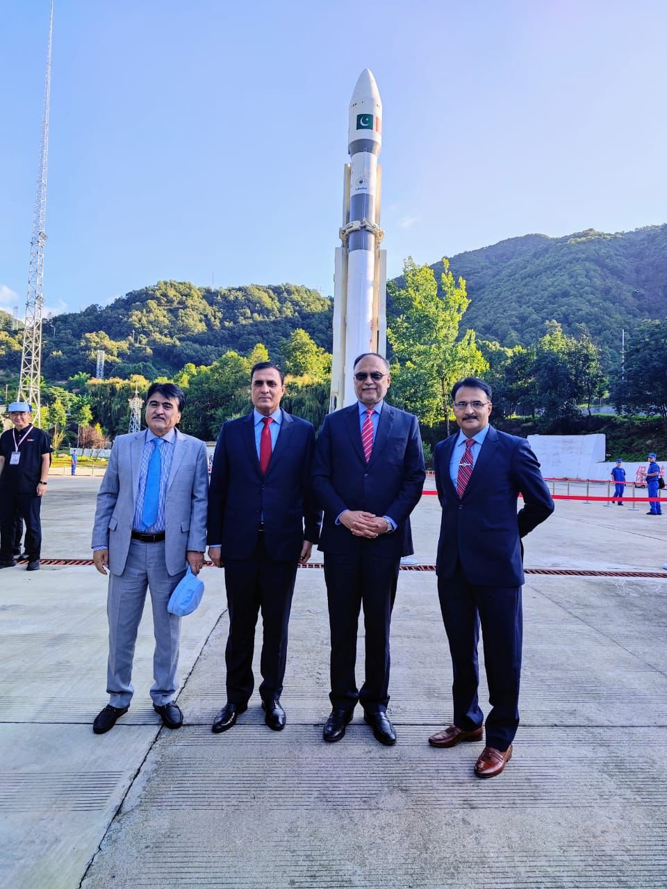 Federal Minister for Planning Ahsan Iqbal (third from left) stands in front of the satellite-carrying spacecraft in this undated image. — Suparco