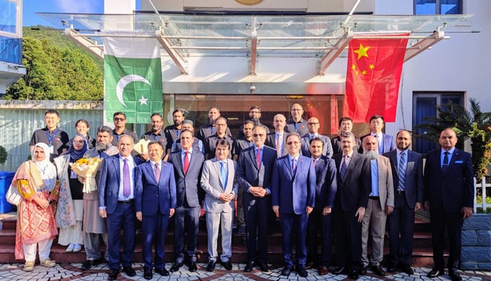 Federal Minister for Planning Ahsan Iqbal (bottom-centre) can be seen with the Suparco team, engineers, and scientists in this undated image. — Suparco
