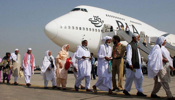 Pakistani pilgrims walk in line as they prepare to board a Pakistan International Airlines special Hajj pilgrimage flight bound for Saudi Arabia at the Allama Iqbal International airport in Lahore. — AFP/File