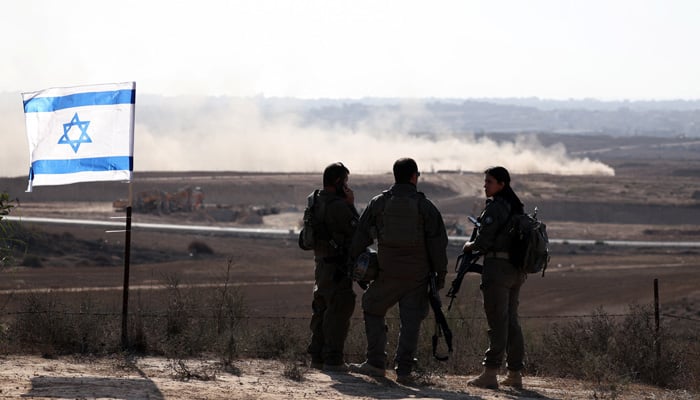 Israeli soldiers stand overlooking the Gaza Strip, as seen from the Israeli side of the Israel-Gaza border, July 30, 2025. — Reuters