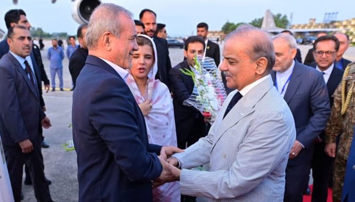 Prime Minister Shehbaz Sharif (right) welcomes Iranian President Masoud Pezeshkian at the Nur Khan Air Base in Islamabad on August 2, 2025. — APP