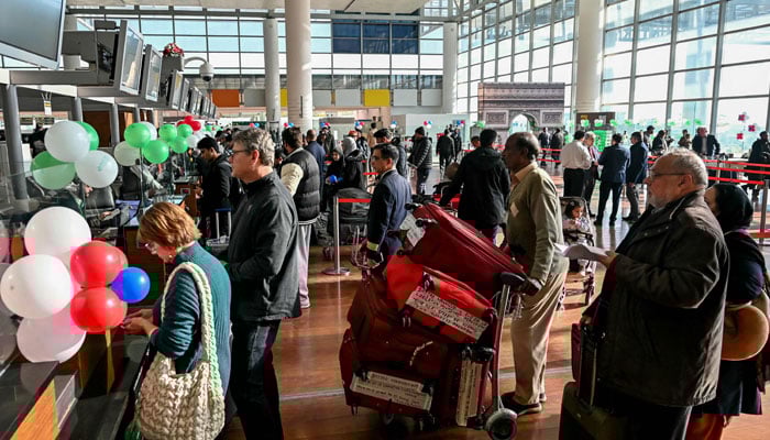 Passengers wait at the immigration counter before boarding at the Islamabad International Airport on January 10, 2025. — AFP