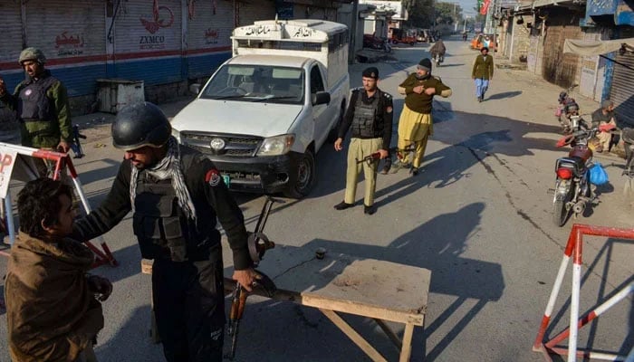 This undated image shows Peshawar police checking civilians on a checkpoint. — AFP/File