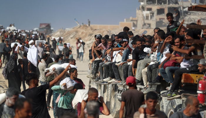 Palestinians carry aid supplies that entered Gaza through Israel, in Beit Lahia, northern Gaza Strip, August 2, 2025. — Reuters