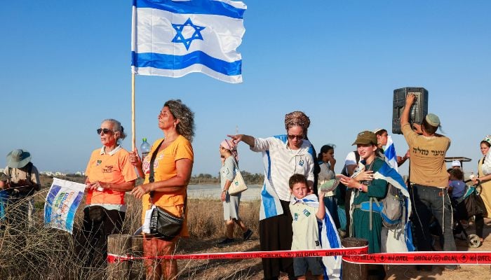 Israeli right-wing protesters gather on a hill overlooking the besieged Gaza Strip near the border fence on July 30, 2025. — AFP