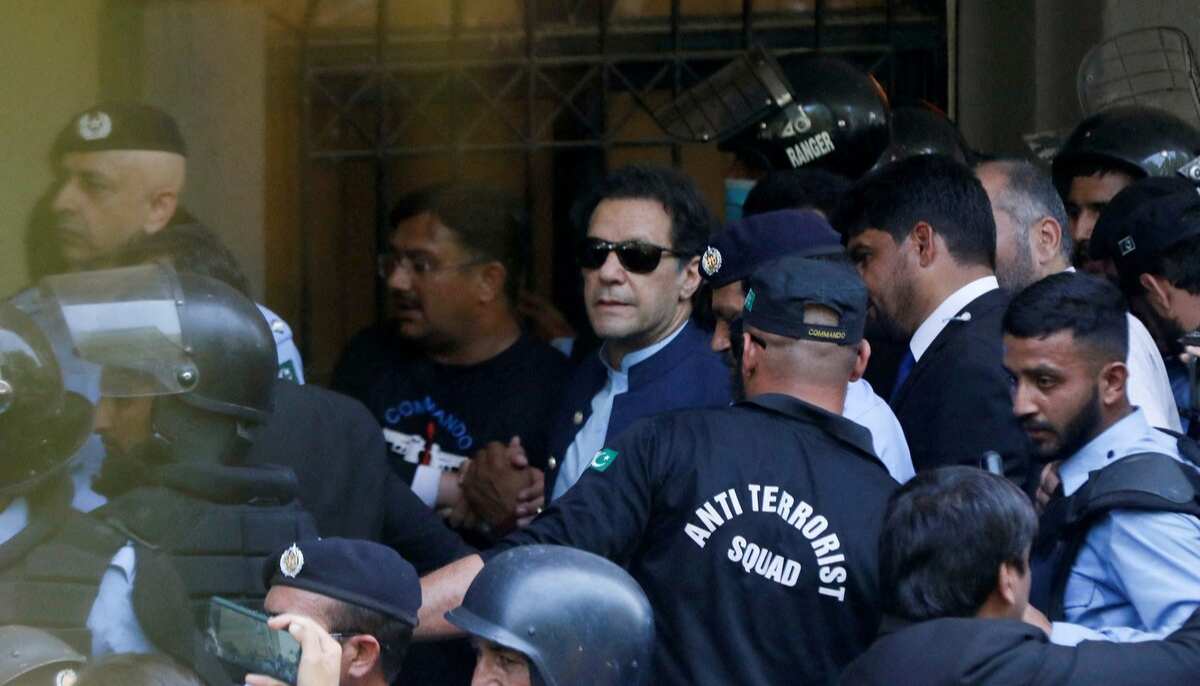 Security officers escort PTI founder Imran Khan, as he appeared in Islamabad High Court, Islamabad on May 12, 2023. — Reuters
