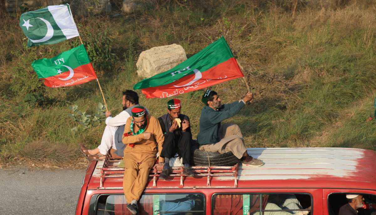 Supporters of the PTI founder Imran Khans party sit atop a vehicle as they head towards Islamabad, during an anti-government rally, in Peshawar on November 24, 2024. — Reuters