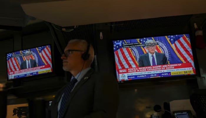 A trader works, as screens broadcast a press conference by U.S. Federal Reserve Chair Jerome Powell following the Fed rate announcement, on the floor of the NYSE in New York, US, July 30, 2025. — Reuters
