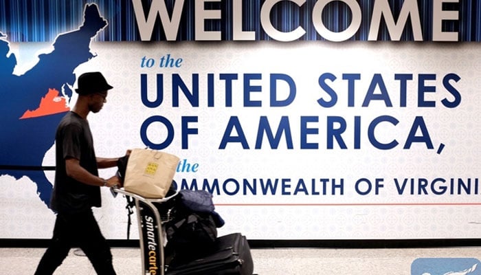 A man exits the transit area after clearing immigration and customs on arrival at Dulles International Airport in Dulles, Virginia, US. — Reuters