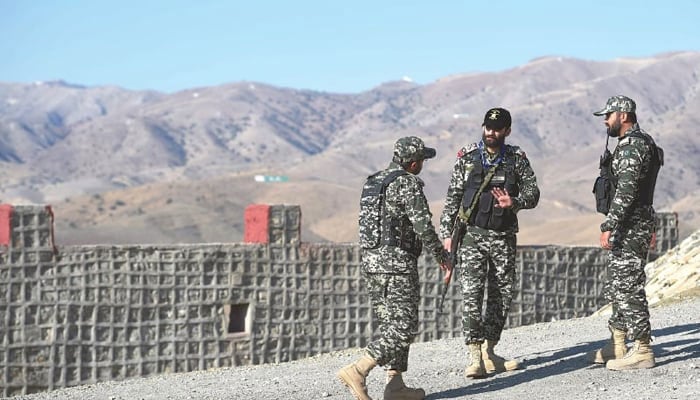 Pakistani soldiers stand guard near the Afghan border in Ghulam Khan, a village in North Waziristan. — AFP