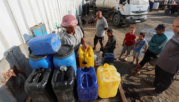 Palestinians collect water amid shortages, at a distribution point in Deir al-Balah in the central Gaza Strip August 5, 2025. — Reuters