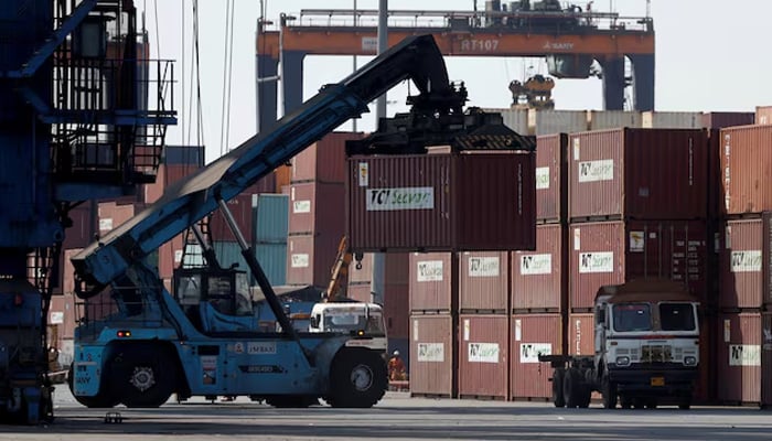 A mobile crane carries a container at Deendayal Port in Kandla, in the western state of Gujarat, India, April 5, 2025. — Reuters