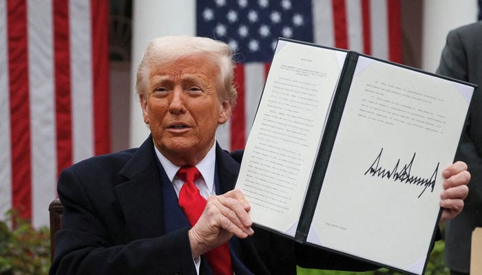 US President Donald Trump holds a signed executive order on tariffs, in the Rose Garden at the White House in Washington, DC  US on April 2, 2025. — Reuters