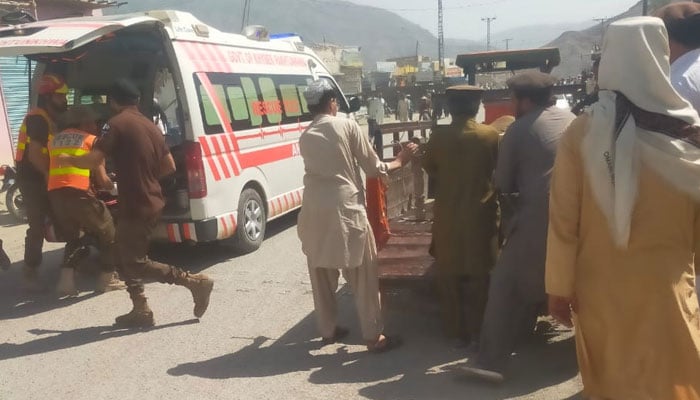 People shift injured to an ambulance at the site of a blast in North Waziristans Lower Wana on August 7, 2025. — Reporter