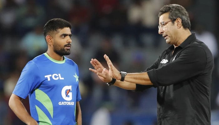 Former Pakistan cricketer Wasim Akram (right) interacts with captain Babar Azam during the rain break in their ACC Mens Asia Cup 2023 Super Four match against India at the R Premdasa Stadium in Colombo on September 10, 2023. — AFP