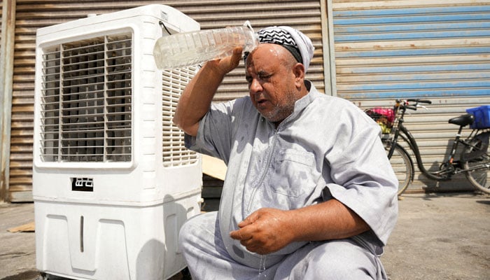 A man cools himself with water during a heatwave in Basra, Iraq, July 28, 2025. — Reuters