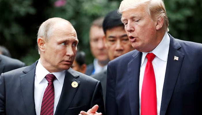 US  President Donald Trump and Russias President Vladimir Putin talk during the family photo session at the APEC Summit in Danang, Vietnam November 11, 2017. — Reuters