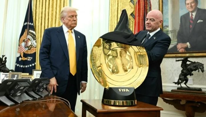 FIFA president Gianni Infantino (R) unveiled the Club World Cup trophy to US President Donald Trump in the Oval Office in March 2025. — AFP