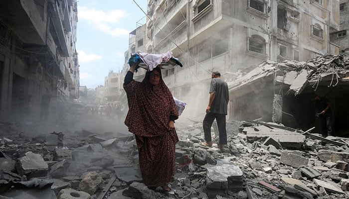 Palestinians inspect the site of a morning Israeli strike on a house, in Gaza City, August 8, 2025. — Reuters
