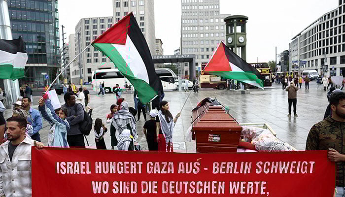 People hold a banner as they protest against Israel and in solidarity with Palestinian children in Gaza, at Potsdamer Platz, in Berlin, Germany, August 3, 2025. — Reuters