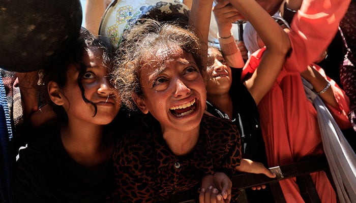 Palestinians wait to receive food from a charity kitchen, amid a hunger crisis, in Khan Younis, southern Gaza Strip, August 4, 2025. — Reuters
