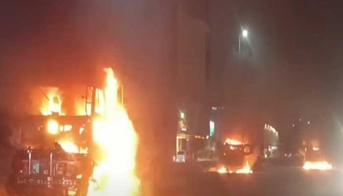Screengrab shows a dumper was set on fire on Rashid Minhas Road in Karachi on August 10, 2025. — Geo News
