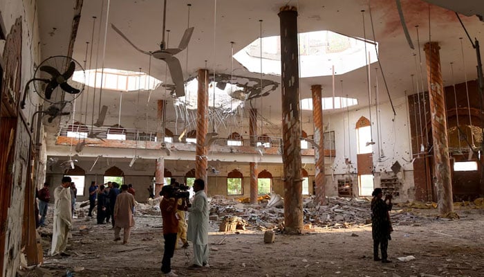 Members of the media film the inside of a building after it was hit by an Indian strike in Bahawalpur on May 7, 2025. — Reuters