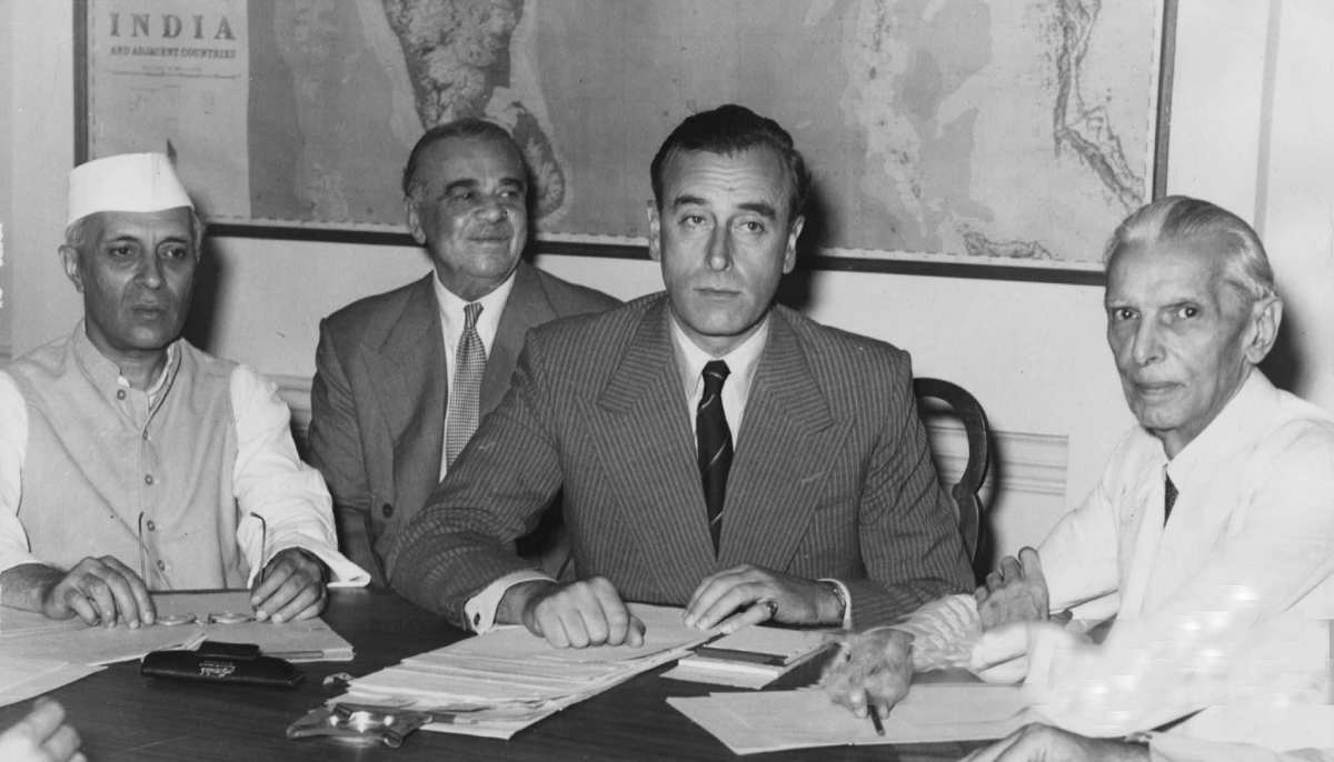 In this photograph Jawaharlal Nehru (left), Lord Ismay, Lord Mountbatten, and Muhammad Ali Jinnah are seated around a table with a map of the subcontinent during the high-stakes discussions leading up to the Partition of British India in June 1947.— The National Archives