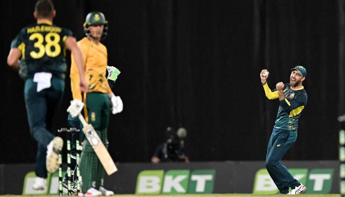 Australian fieldsman Glenn Maxwell (R) celebrates as he takes a catch during the T20I match between Australia and South Africa played in Darwin on August 10, 2025. — AFP