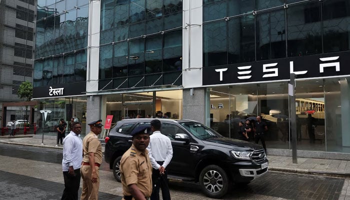 Police officers direct traffic outside the Tesla showroom ahead of its opening in Mumbai, India, July 15, 2025. — Reuters