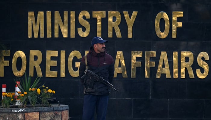 A police officer stands guard outside the Ministry of Foreign Affairs in Islamabad on January 18, 2024. — AFP