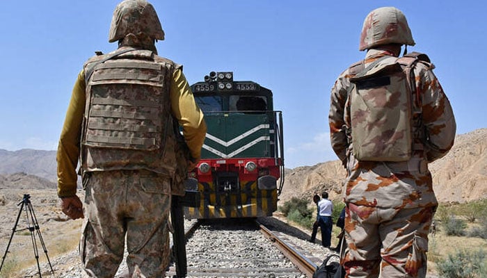 Frontier Corps soldiers stand guard at the siege site after terrorists ambushed a train in the remote mountainous area, at Pehro Kunri in Balochistan on March 15, 2025. — Reuters