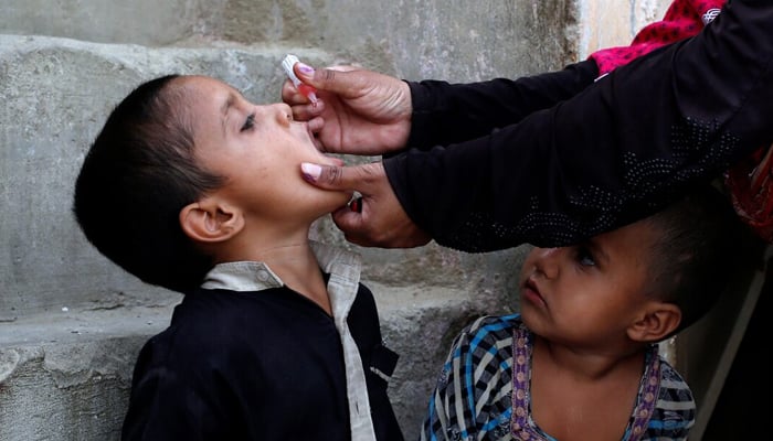 A boy receives polio vaccine drops, during an anti-polio campaign, in Karachi, on April 9, 2018. — Reuters