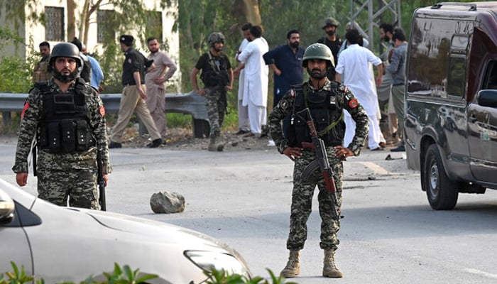 Security personnel gather at the site after the bomb blast in Hayatabad area of Peshawar on July 18, 2023. — AFP