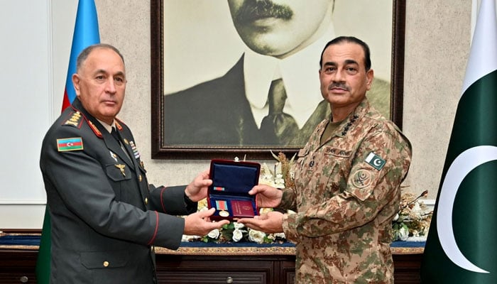 Field Marshal Asim Munir (right) receives the Patriotic War Medal from Azerbaijan’s top commander at GHQ. — ISPR