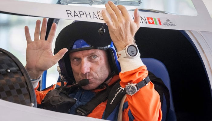 Swiss pilot Raphael Domjan waves before taking off in his first attempt of the season at setting a new aviation record by reaching an altitude of 10,000 metres onboard the solar-powered plane SolarStratos at the Sion airport, in Sion, southwestern Switzerland, on August 8, 2025. — AFP