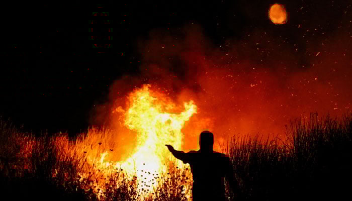 A firefighter works as a wildfire continues to burn near Delvina, Albania, August 12, 2025. — Reuters