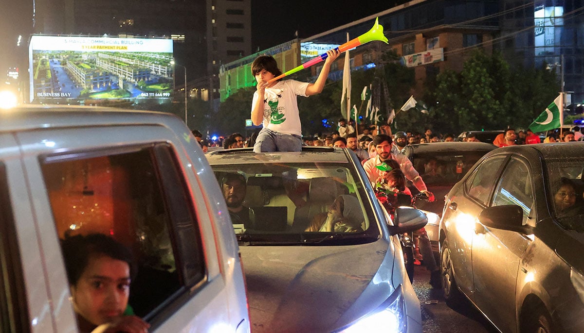 A child uses a vuvuzela during Independence Day celebration in Lahore on August 14, 2025. — Reuters