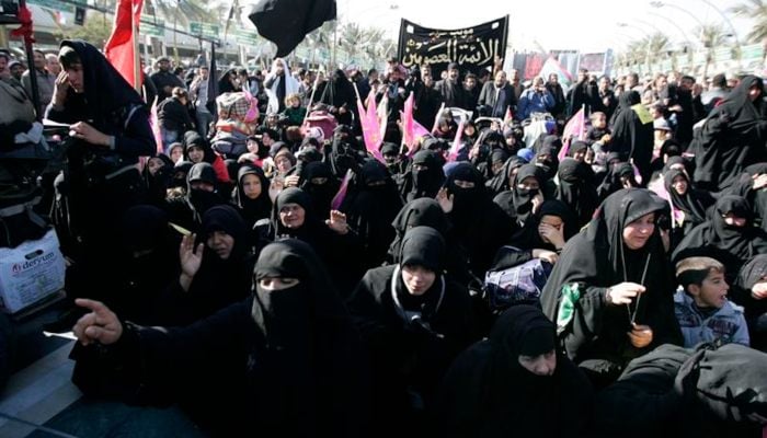 Pilgrims take part in a ceremony to mark the religious ritual of Arbaeen in Kerbala, about 80 km (50 miles) southwest of Baghdad, December 24, 2013. — Reuters
