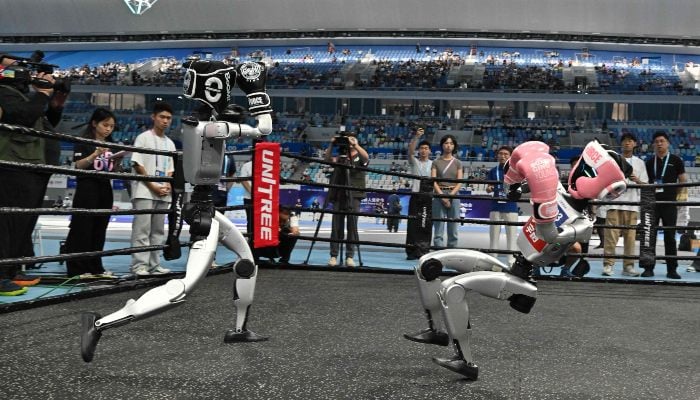 Two robots fight in a free combat style event during the World Humanoid Robot Games in Beijing on August 15, 2025. — AFP