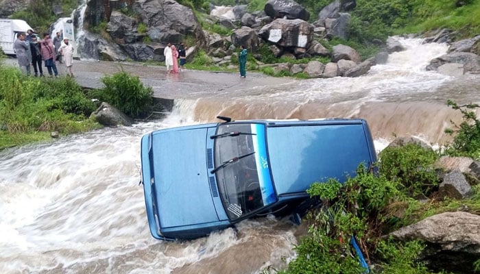 This photo shows a car being washed away by a flash flood in Mansehra, KP, on August 15, 2025. — PPI