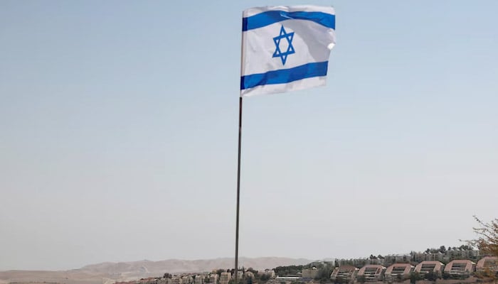 An Israeli flag flutters, as part of the Israeli settlement of Maale Adumim is visible in the background, in the Israeli-occupied West Bank, August 14, 2025. — Reuters