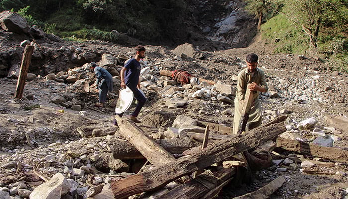 Residents recover belongings from the remains of a damaged home after a cloudburst triggered heavy rains and flooding in Naryan Behak village on the outskirts of AJK’s Muzaffarabad, on August 15, 2025. — Reuters