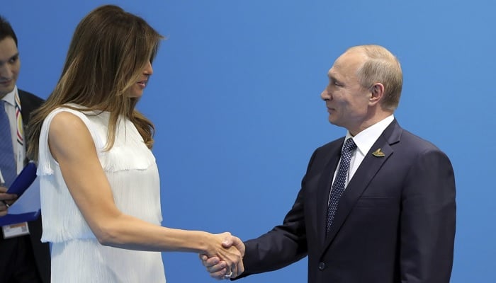Russian President Vladimir Putin shakes hands with US first lady Melania Trump during a meeting on the sidelines.— Reuers/File