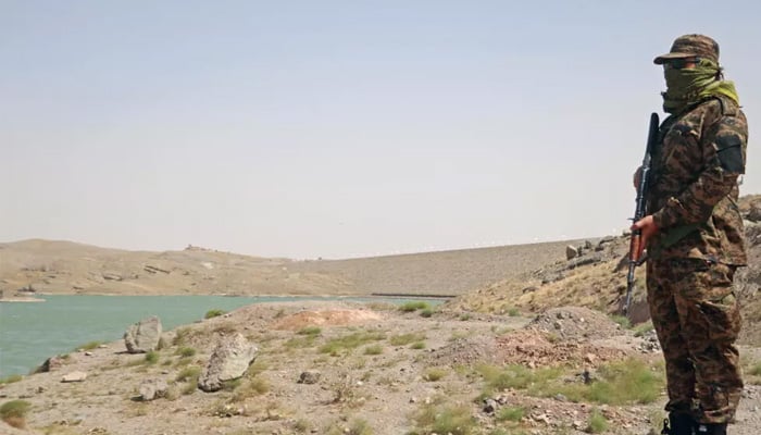 A member of Taliban security forces stands guard near the Pashdan Dam, also known as Band-e Pashdan, in Herat province. — AFP