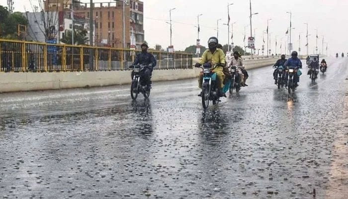 Motorcyclists can be seen on the road of Karachi during light rain. — Geo.tv/File