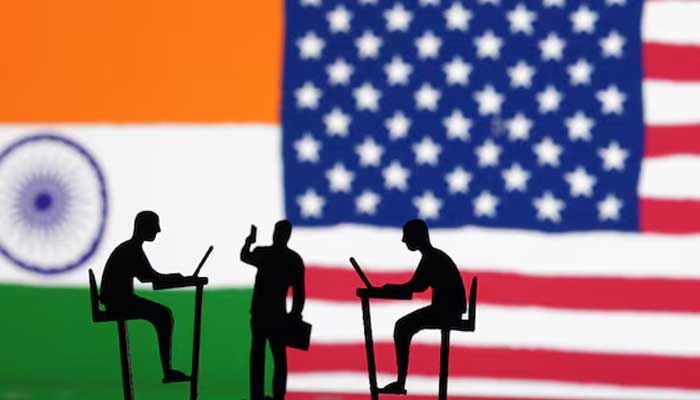 The Indian flag, the US flag and people miniatures, some with laptops, are seen in this illustration taken March 10, 2024. — Reuters