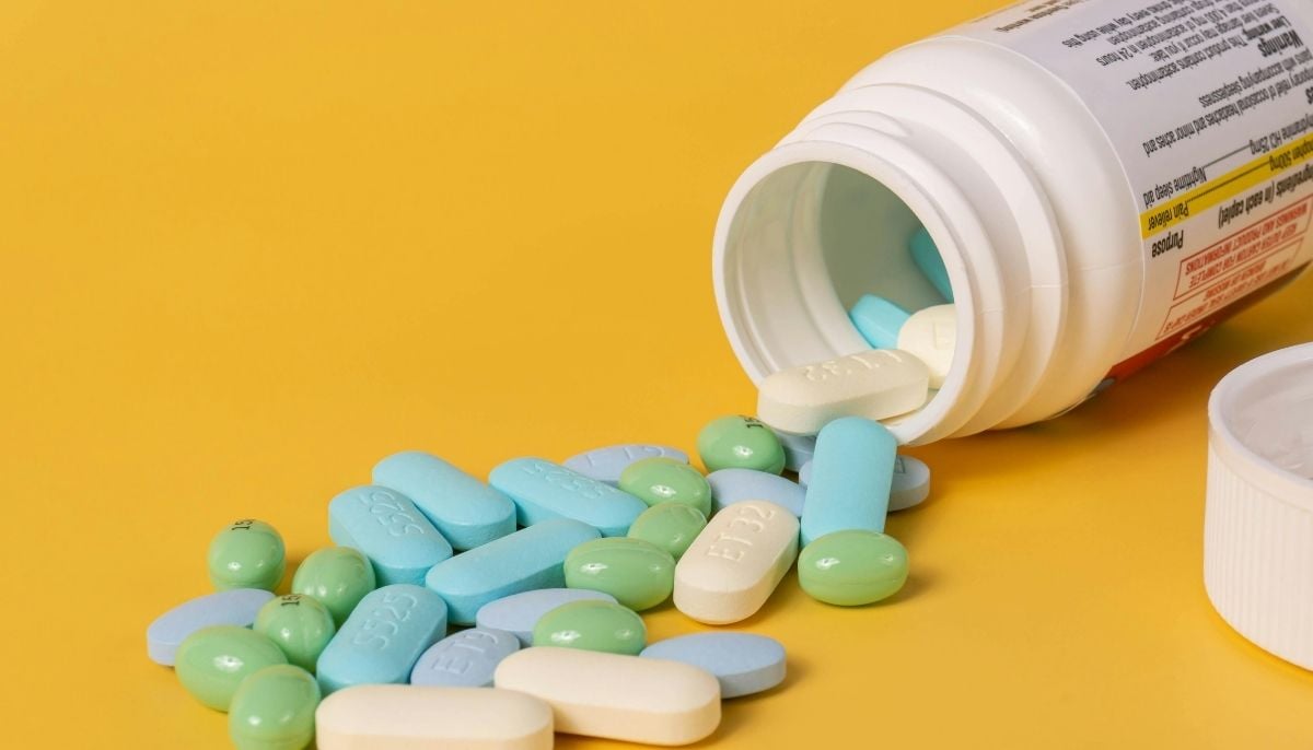 A representational image of medicines scattered out of its container. — Canva