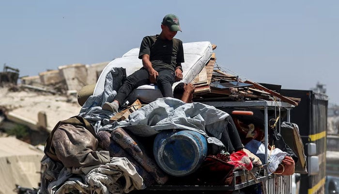 Displaced Palestinians fleeing northern Gaza travel in a vehicle while they head south as the Israeli military prepares to relocate residents to the southern part of the enclave, in Gaza City, August 18, 2025. — Reuters
